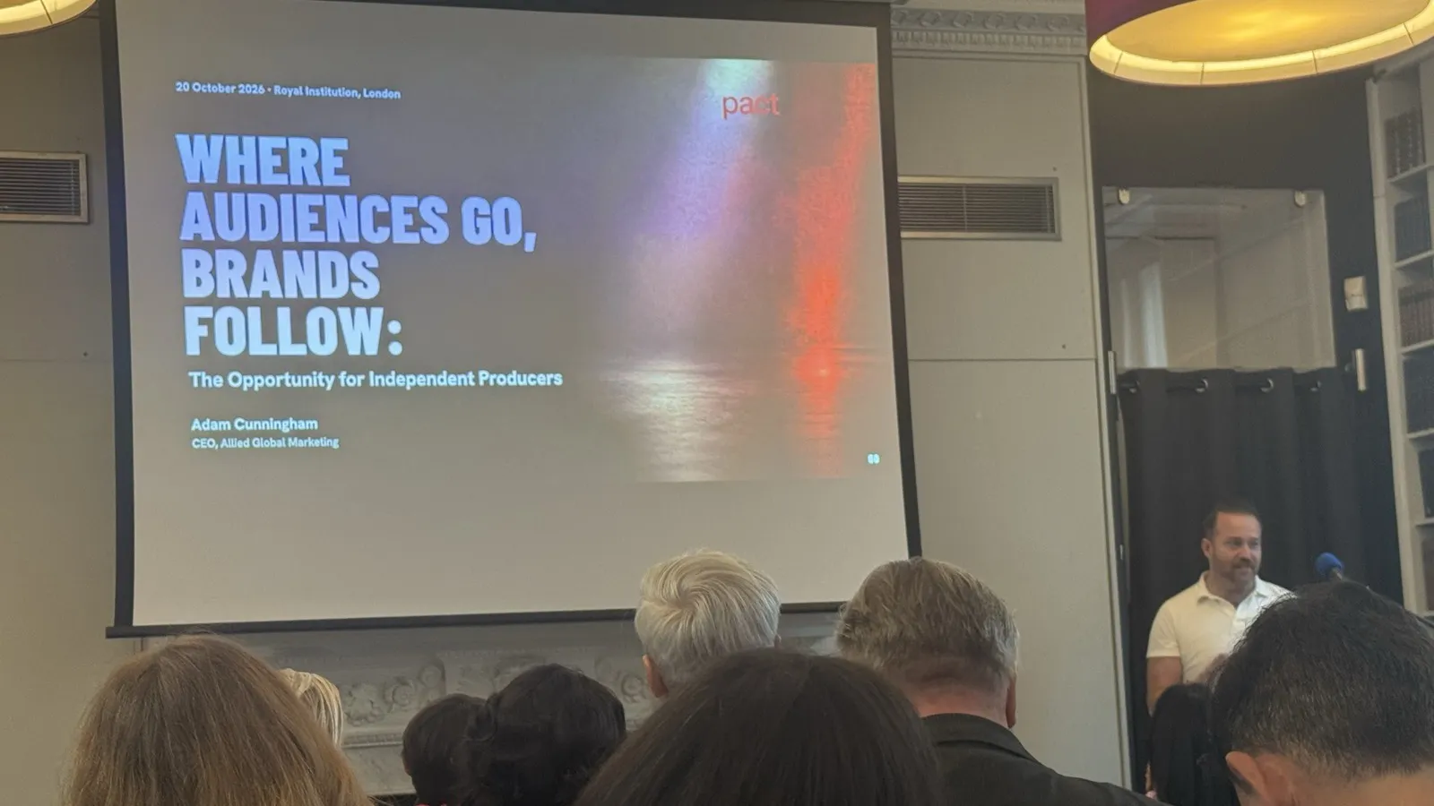 An audience at Pact's brands event at the Royal Institution watching a talk titled 'Where Audiences Go, Brands Follow: The Opportunity for Independent Producers'